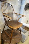 A 19th century Windsor style beech hoop back chair, brass label for S. Gainsford & Co., London