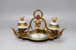 A late 19th century ormolu and 'Sevres' inkstand with cherub and floral decoration - 29cm long
