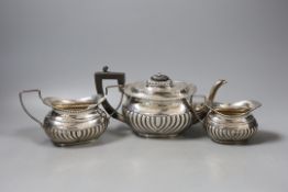 A matched late Victorian demi-fluted silver three piece tea set, Birmingham, 1896/7,gross weight