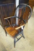 A 19th century Windsor elm and ash wheelback elbow chair (a.f.)