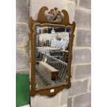 A George III style walnut fret cut wall mirror, width 47cm, height 86cm
