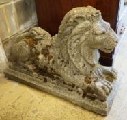 A reconstituted stone recumbent lion ornament, length 74cm, height 50cm