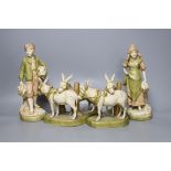 A pair of Royal Dux figures and a pair of Royal Dux donkey groups, 24cm