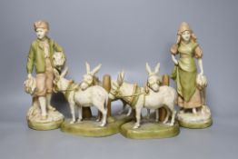 A pair of Royal Dux figures and a pair of Royal Dux donkey groups, 24cm