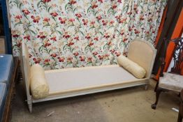 A Louis XVI style yellow painted upholstered French daybed, width 198cm, depth 69cm, height 88cm