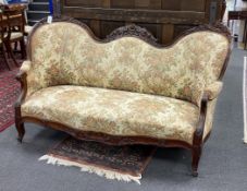 A Victorian upholstered carved mahogany double spoonback settee, width 176cm, depth 74cm, height