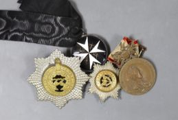 An Edwardian ‘Fear God Honour the King’ medal, ‘The Cheshire Regiment’ badge, and two other medals