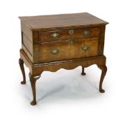 A mid 18th century featherbanded walnut chest on stand, with moulded quarter veneered top, one