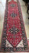A North West Persian style red ground blue field runner, 280 x 78cm