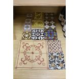 A selection of 19th and 20th century tiles, including Minton encaustic and W. Godwin tiles
