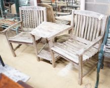 A weathered teak duet garden bench, length 170cm, depth 56cm, height 86cm