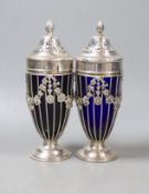 A pair of George V pierced silver sugar sifters, with blue glass liners, London, 1912, height 17.