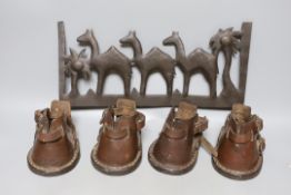 A set of four antique stitched leather pony shoes