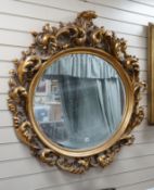 A large moulded gilt frame oval mirror, width 112cm height 110cm