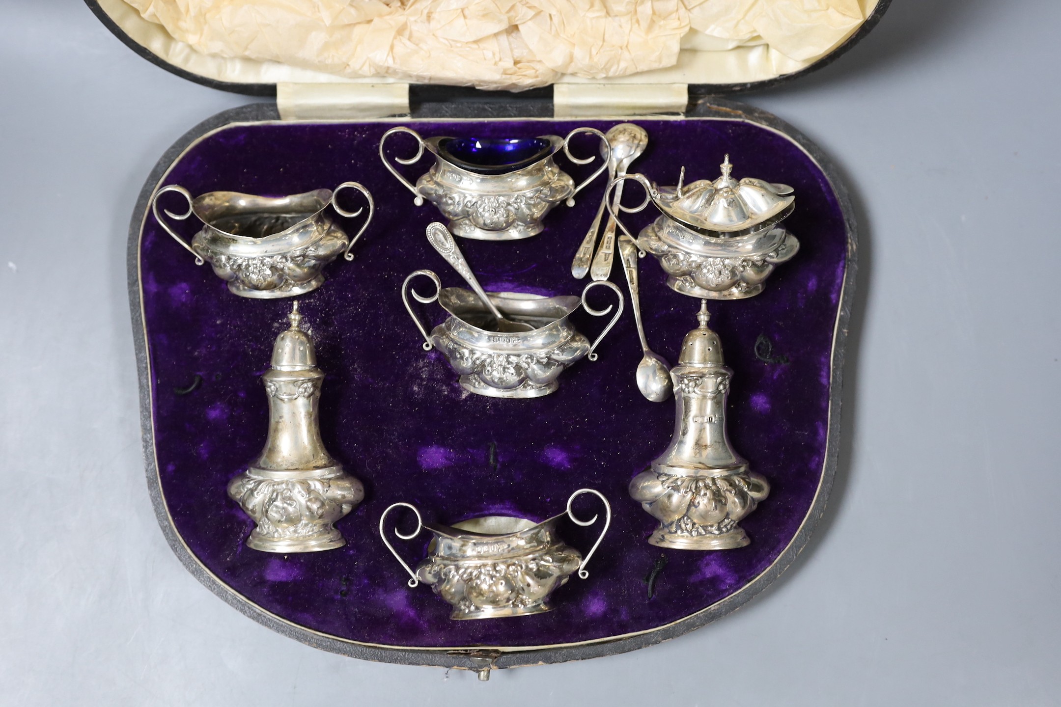 A late Victorian embossed silver six piece condiment set, together with four spoon, Sheffield, 1901, - Image 2 of 2