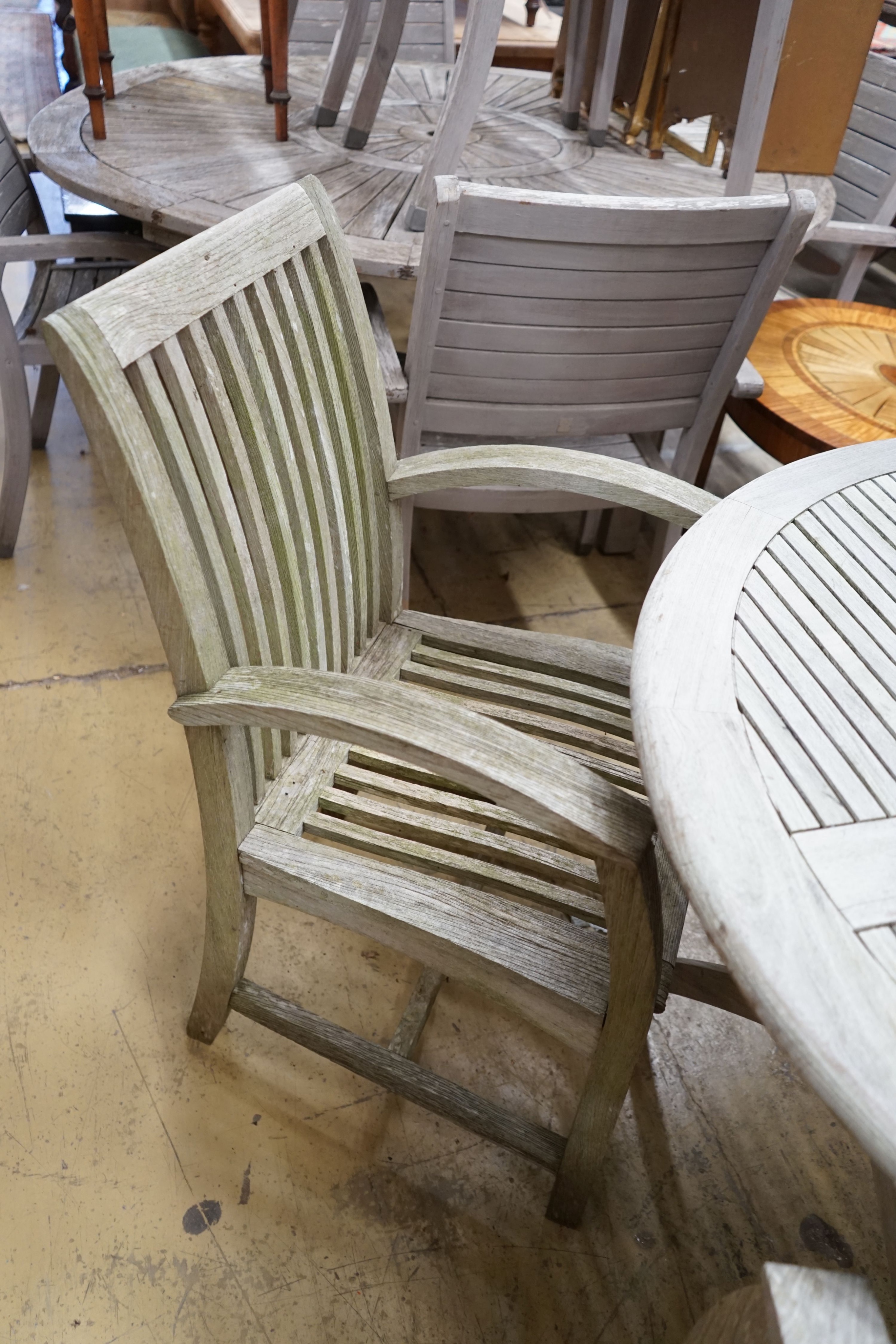 A circular weathered teak folding garden table, diameter 120cm, height 74cm and four teak chairs - Image 2 of 3