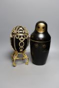 An advertising Smirnoff Russian doll metal bottle holder and an egg shaped and diamanté ice bucket,