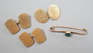 A pair of 9ct gold cufflinks, one other single 9ct gold cufflink and a 9ct and gem set bar brooch,