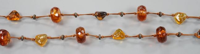 A ingle strand faceted and pebble amber necklace, 138cm.