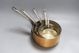 A set of 5 graduated Faucogney copper saucepans