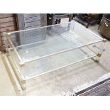 A contemporary metal and bevelled glass two tier coffee table, width 128cm, depth 77cm, height 40cm