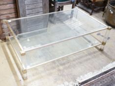 A contemporary metal and bevelled glass two tier coffee table, width 128cm, depth 77cm, height 40cm