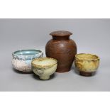 Two Japanese stoneware tea bowls (chawan), a Japanese raku bowl and a Japanese carved wood tea