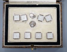 A cased eight piece 9ct white metal and seed pearl set dress stud set, gross 10.8 grams.