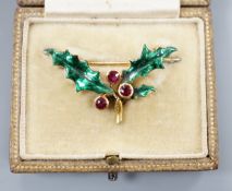A cased yellow metal, ruby and green enamel set 'holly and berry' brooch, 36mm, gross weight 5