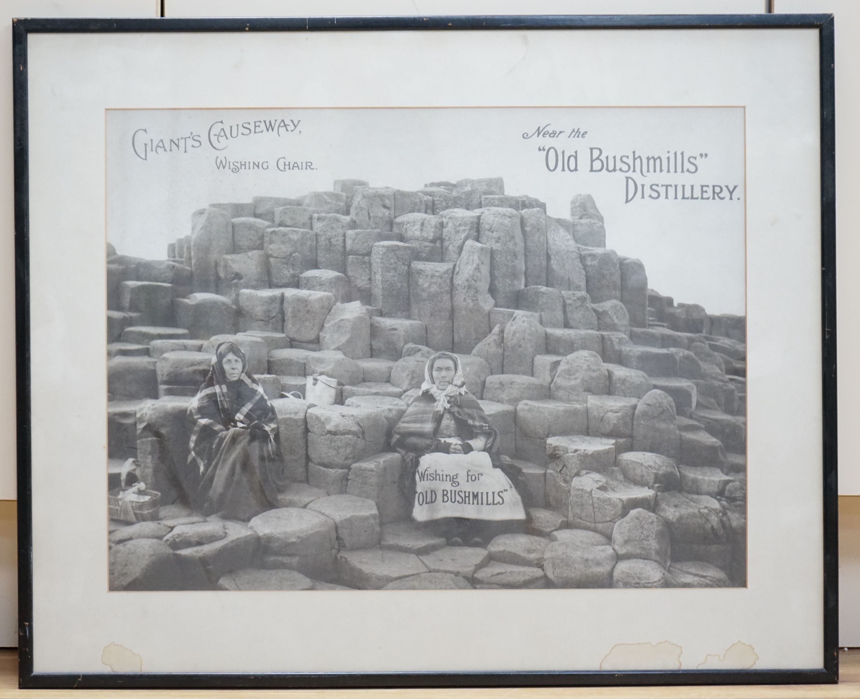 A monochrome advertising print for Old Bushmills Distillery, Giants Causeway, Wishing Chair, 39 x - Image 2 of 2