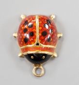 A modern yellow metal and two colour enamel set ladybird pendant, overall 19mm, gross weight 1.7