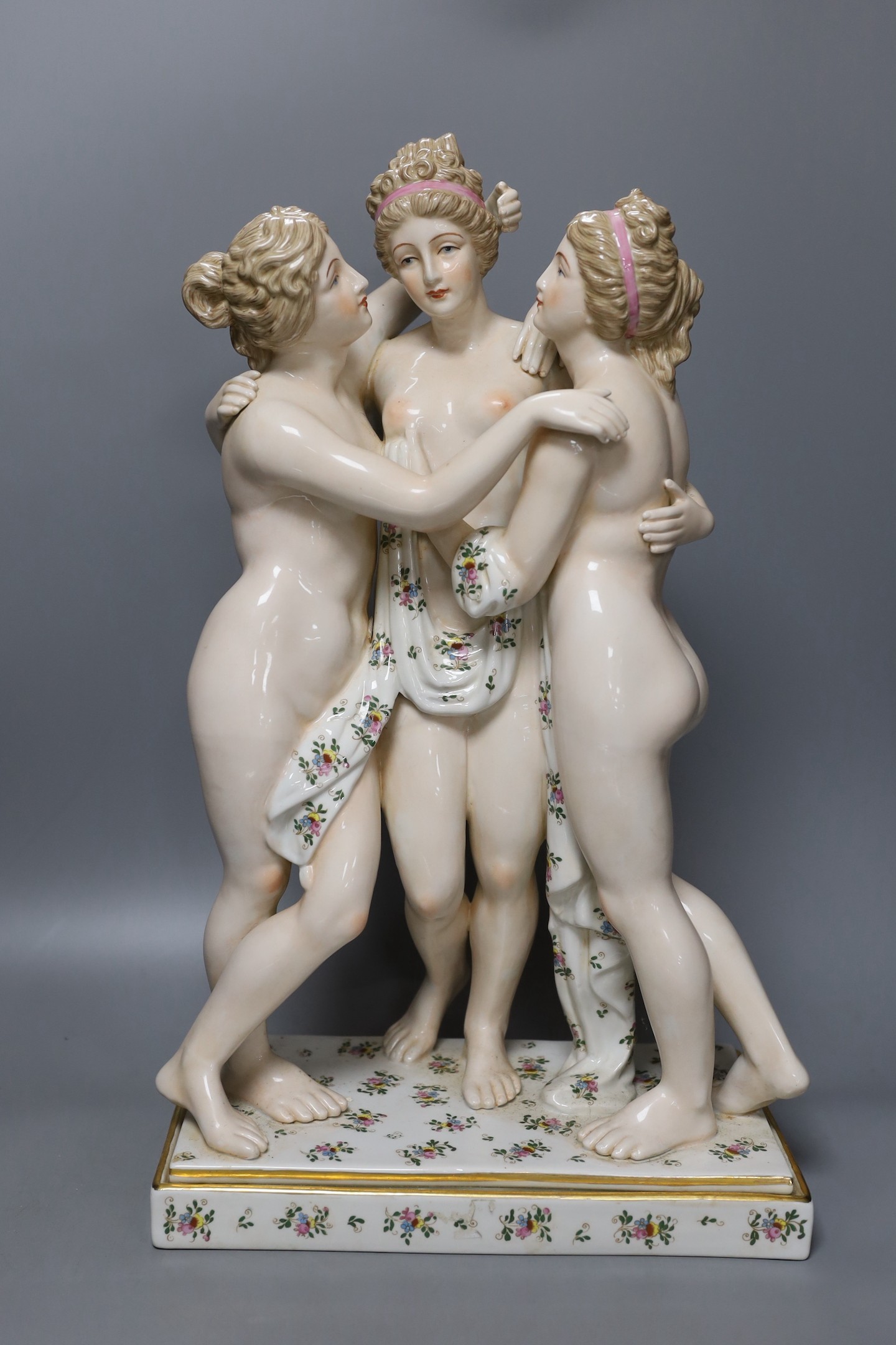 A large German porcelain figure group, the Three Graces, 49cm