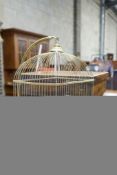 A brass ‘GenyKage’ canary cage on telescopic brass stand, width 31cm depth 23cm height 162cm