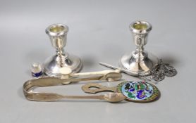 A group of mixed silver, to include sugar tongs, a pair of candlesticks, an Indian silver enamel