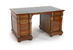 An early 20th century French classical revival mahogany breakfront pedestal desk, with dark green