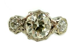 A white gold and collet set three stone diamond ring, the central stone weight approximately 2.08ct,