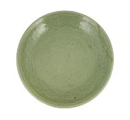 A rare large Chinese Ming Longquan celadon dish, 14th century, the centre carved with lotus flowers,