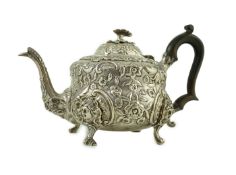 An early Victorian embossed silver teapot, by William Moulson, with engraved crest with coronet