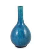 A Chinese turquoise glazed sgraffito bottle vase, 19th century, incised with two lion-dogs playing