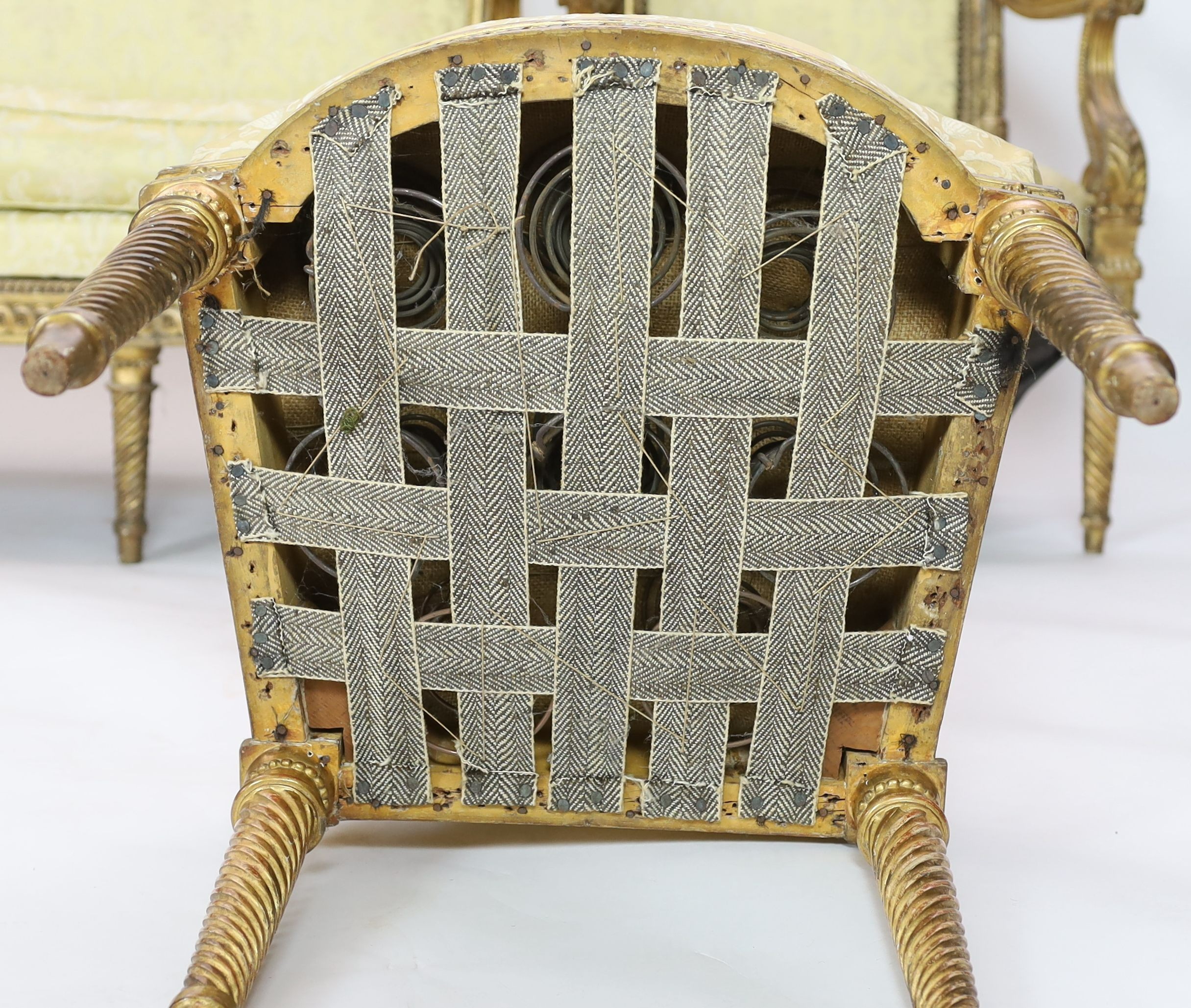 A Louis XVI carved giltwood five piece salon suite, comprising settee, pair of armchairs and pair of - Image 5 of 5