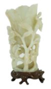 A large Chinese pale celadon jade ‘magnolia’ cup, 17th/18th century carved in high relief and