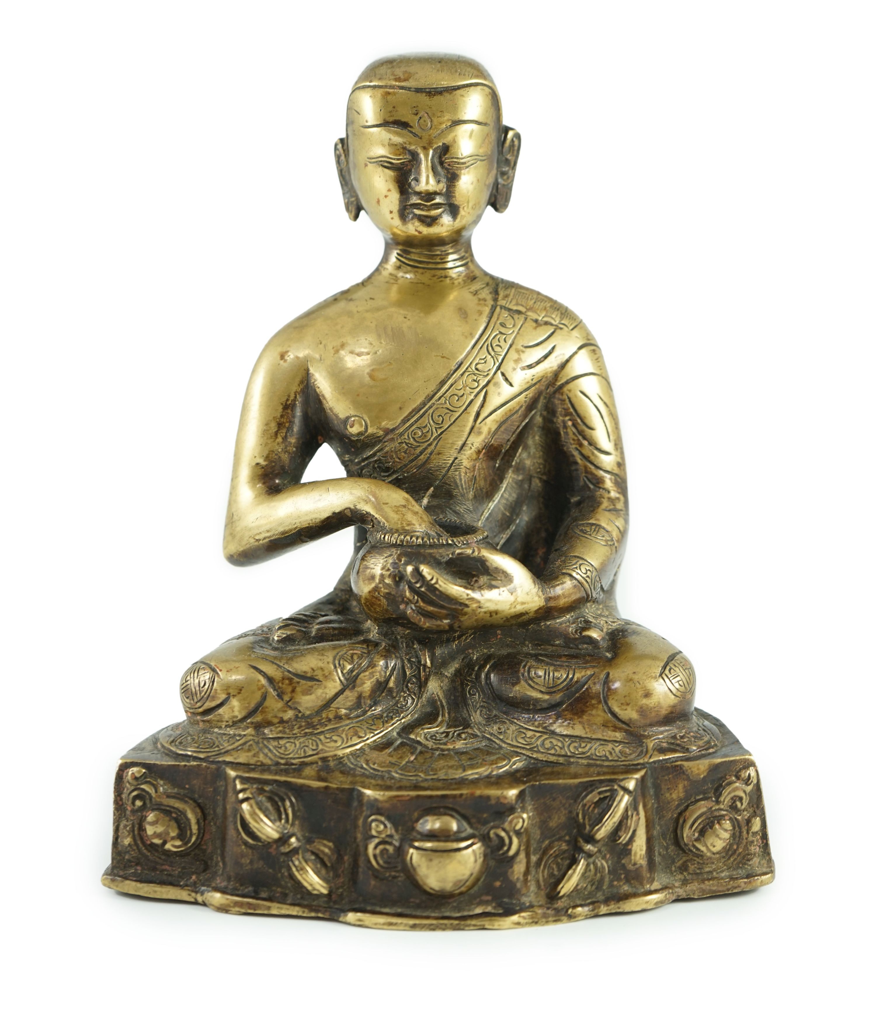 A Himalayan bronze figure of Buddha, 19th century, the seated figure holding an alms bowl, the