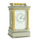 A late 19th century French hour repeating silvered and gilt brass carriage clock, in architectural