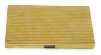 A 20th century Cartier ribbed 18ct gold and sapphire set rectangular cigarette case, the