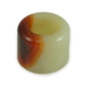 A Chinese pale celadon and russet jade archer's ring, early 20th century 3.4 cm diameterNatural