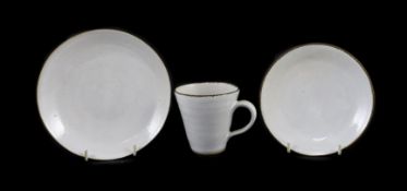 Dame Lucie Rie (1902-1995) a cup, saucer and side plate, c.1959, each white glazed stoneware with