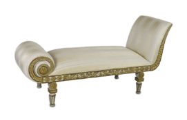 A Regency white painted and parcel gilt chaise longue, decorated throughout with foliate motifs,
