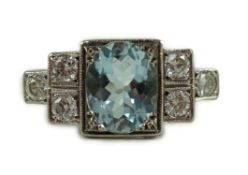 An 18ct white gold oval cut aquamarine and six stone diamond cluster set dress ring, size O, gross