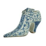 A documentary English delftware blue and white model of a shoe, dated 1732, painted with bands of
