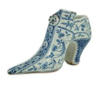 A documentary English delftware blue and white model of a shoe, dated 1732, painted with bands of